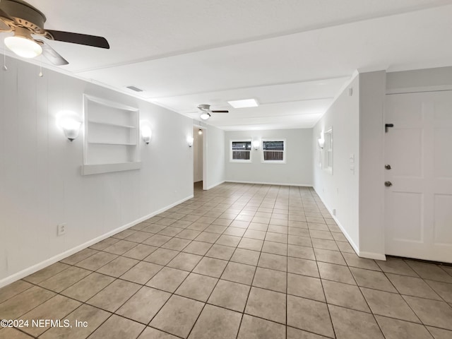 tiled empty room with ceiling fan