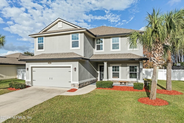 view of front facade with a garage and a front lawn