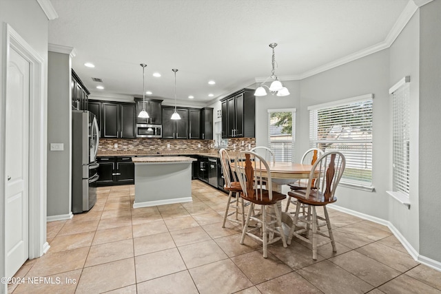 kitchen with tasteful backsplash, decorative light fixtures, light tile patterned floors, a kitchen island, and stainless steel appliances