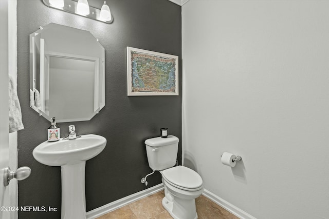 bathroom with toilet and tile patterned flooring