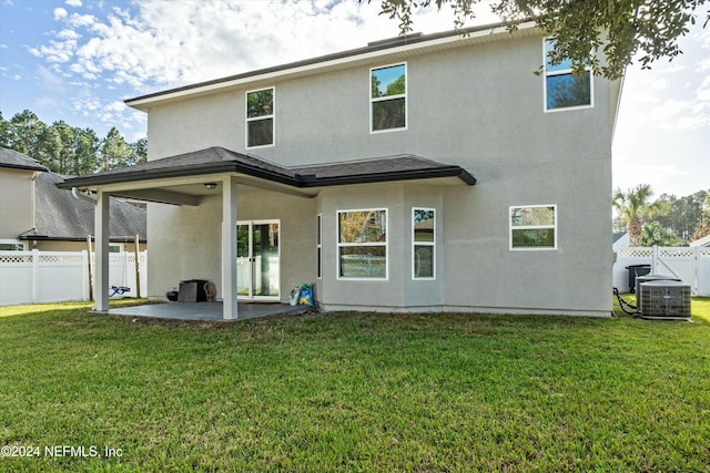 rear view of house with a yard, central AC unit, and a patio