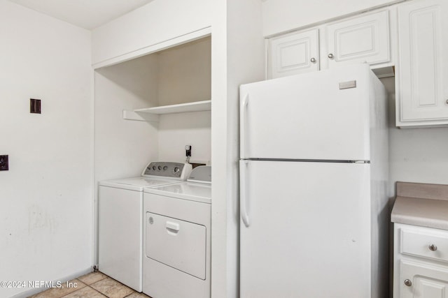 washroom featuring separate washer and dryer and light tile patterned floors