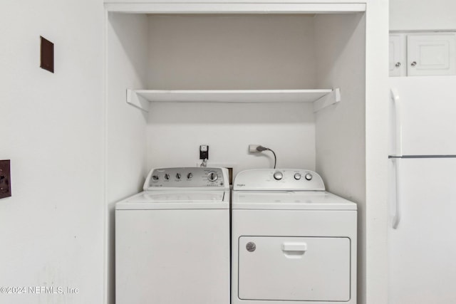 clothes washing area featuring washing machine and clothes dryer