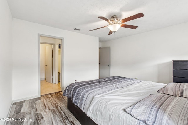 bedroom with ceiling fan and wood-type flooring