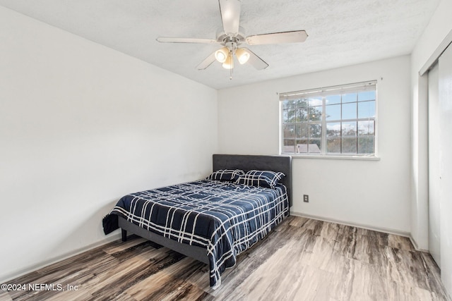 bedroom with hardwood / wood-style flooring and ceiling fan