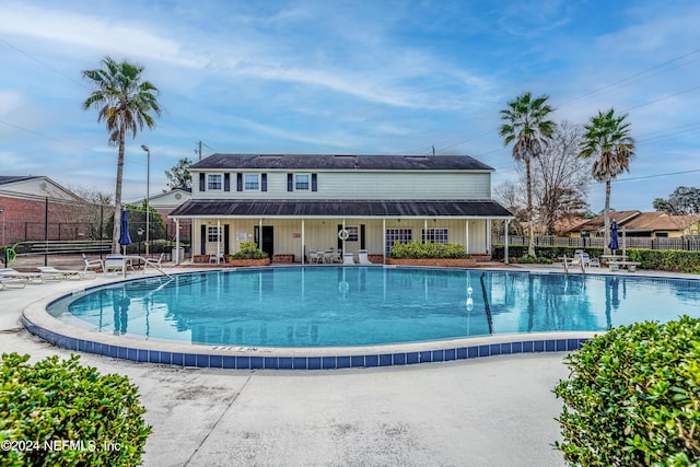 view of swimming pool with a trampoline