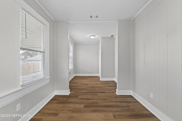 hall featuring crown molding and dark wood-type flooring