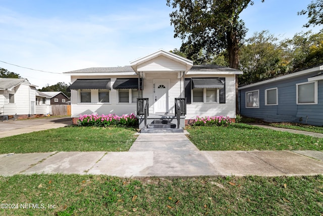 bungalow featuring a front lawn