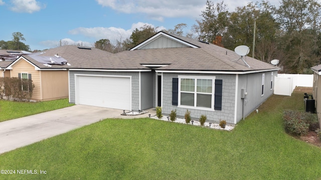 single story home with a garage and a front lawn