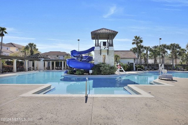 view of swimming pool featuring a water slide