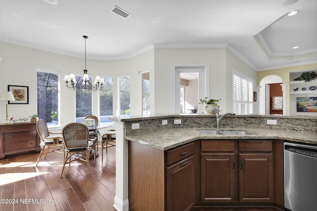 kitchen with dishwasher, dark wood-type flooring, sink, light stone counters, and a chandelier