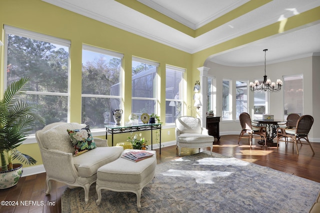 sunroom / solarium with ornate columns and a notable chandelier