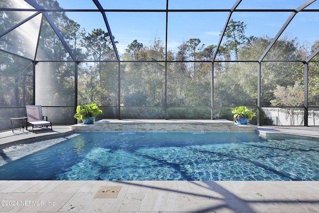 view of pool featuring a patio area and a lanai