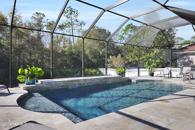 view of swimming pool featuring pool water feature, glass enclosure, and a patio