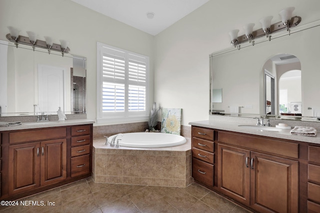 bathroom with vanity, tiled bath, and tile patterned floors