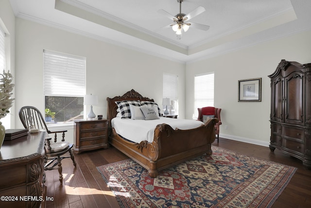 bedroom with a raised ceiling, ceiling fan, dark hardwood / wood-style floors, and ornamental molding