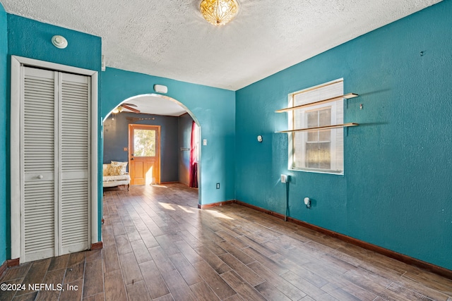 unfurnished room with a textured ceiling