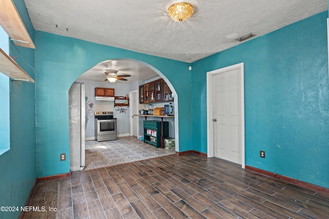 unfurnished living room with ceiling fan and a textured ceiling