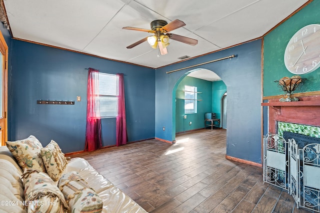 living room with ceiling fan and a tile fireplace