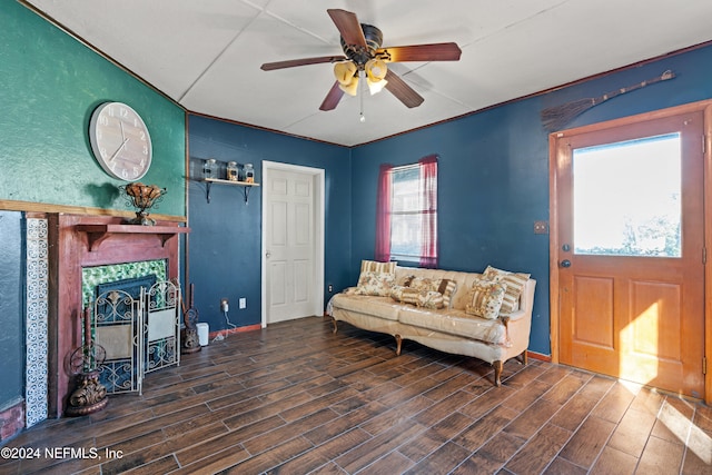 interior space featuring ceiling fan and a tiled fireplace