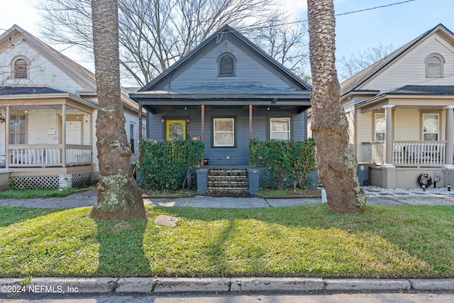 bungalow with a porch and a front yard