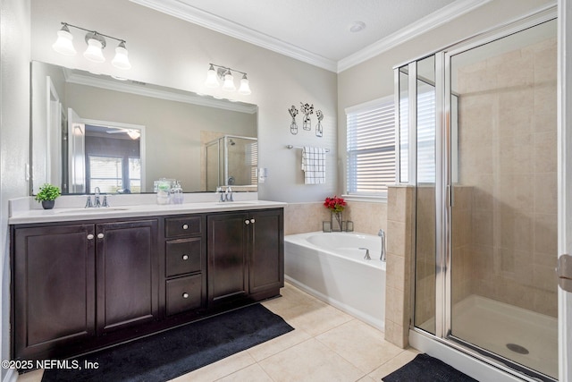 bathroom with tile patterned floors, crown molding, vanity, and shower with separate bathtub