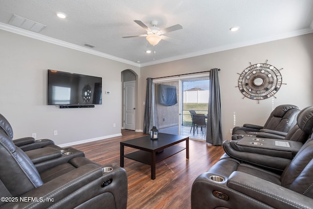 living room with crown molding, ceiling fan, and dark hardwood / wood-style floors