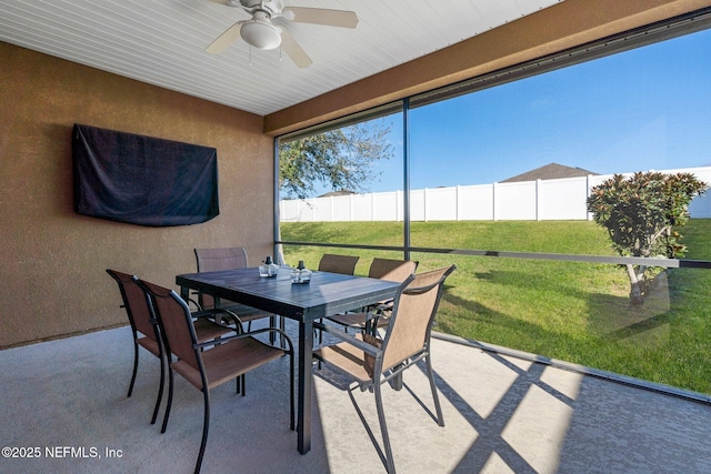 sunroom / solarium featuring ceiling fan