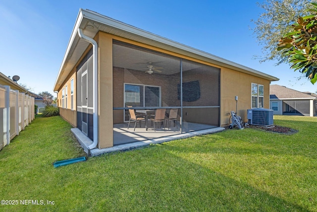 rear view of property with central air condition unit, ceiling fan, a yard, and a patio