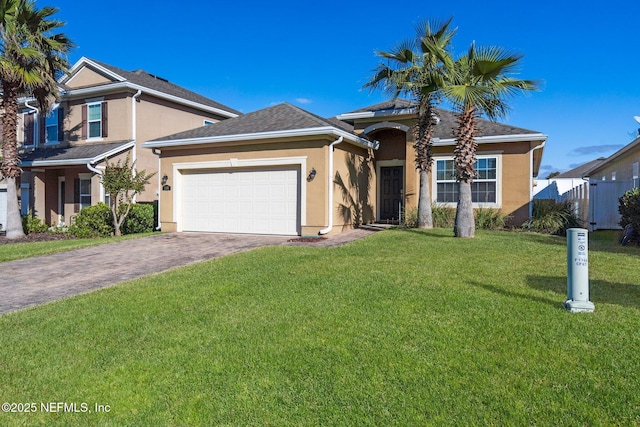 view of front of house featuring a garage and a front lawn