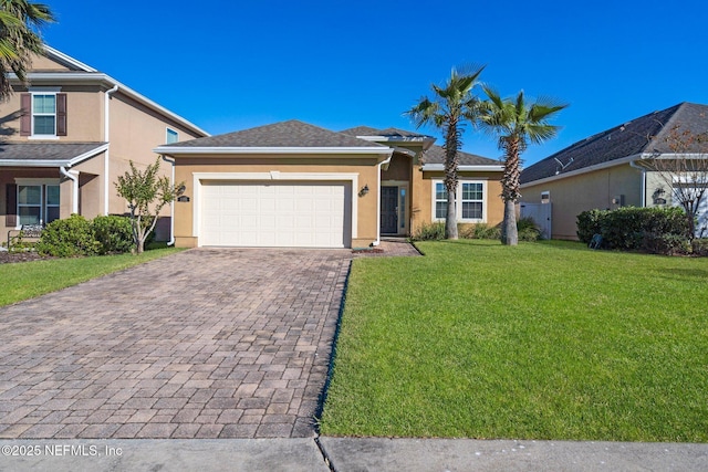 view of front of house featuring a garage and a front lawn