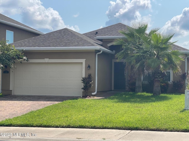 view of front of home with a front yard and a garage