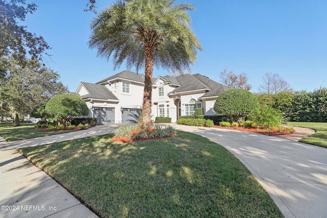 view of front of house with a front yard and a garage