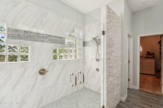 bathroom featuring a shower with door