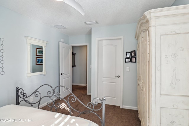 carpeted bedroom with a textured ceiling and ceiling fan