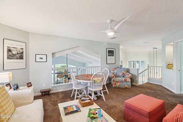 living room featuring dark colored carpet, ceiling fan, lofted ceiling, and a textured ceiling