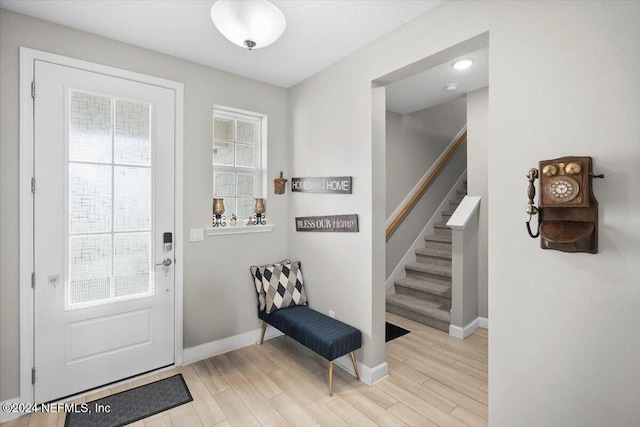 foyer entrance with light hardwood / wood-style floors