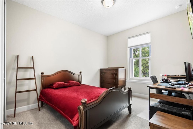 carpeted bedroom featuring a textured ceiling