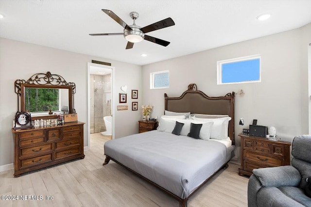 bedroom with ensuite bath, light hardwood / wood-style floors, and ceiling fan