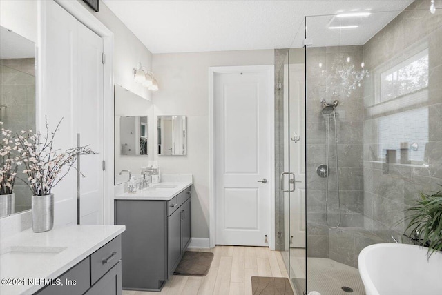 bathroom featuring independent shower and bath, vanity, and hardwood / wood-style floors