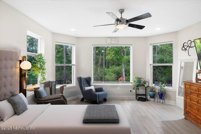 bedroom with a ceiling fan, baseboards, and wood finished floors