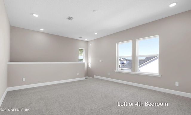 empty room with baseboards, carpet flooring, and recessed lighting