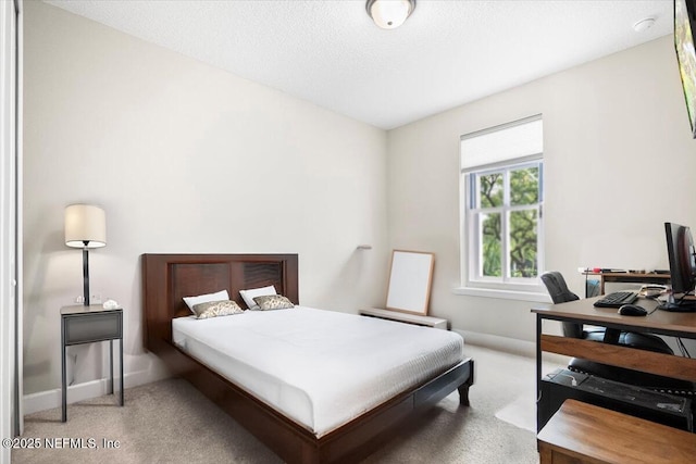 bedroom featuring a textured ceiling, baseboards, and carpet flooring