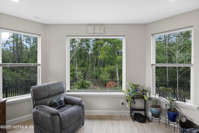 living area featuring wood finished floors and a healthy amount of sunlight