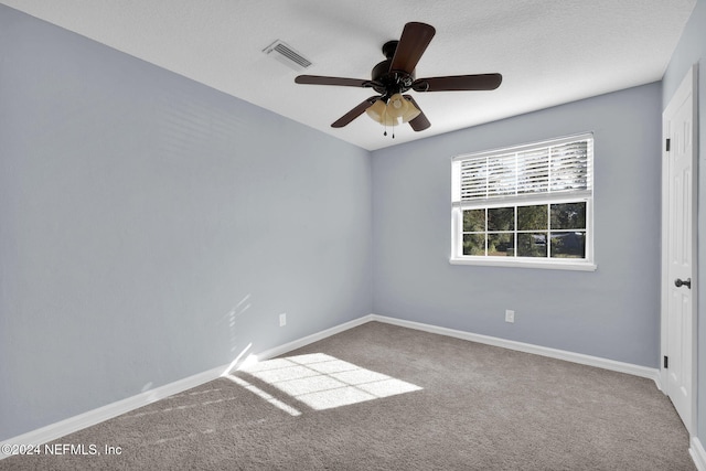 empty room with ceiling fan and carpet flooring