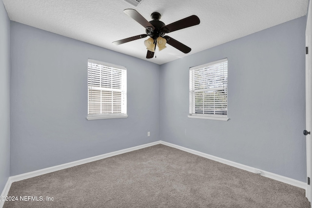 empty room featuring ceiling fan, carpet flooring, and a textured ceiling