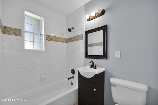 full bathroom with toilet, tiled shower / bath, and vanity