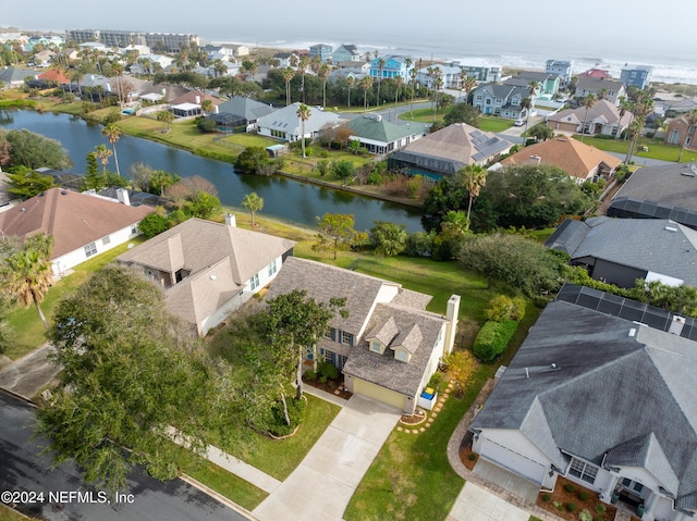 birds eye view of property with a water view