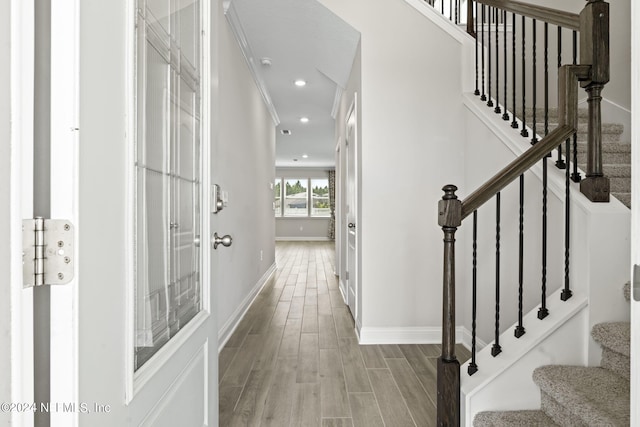 interior space with crown molding and light hardwood / wood-style flooring