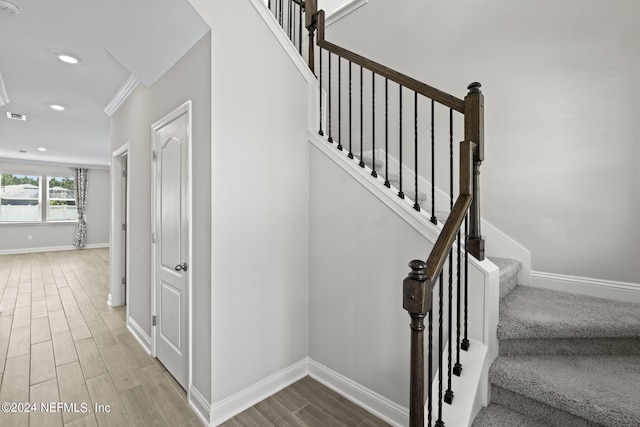 stairs featuring hardwood / wood-style flooring